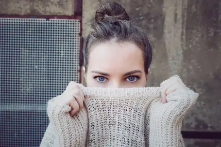 woman wearing sweater with eyes only visible
